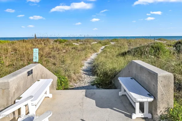 a view of a balcony with chair and wooden floor