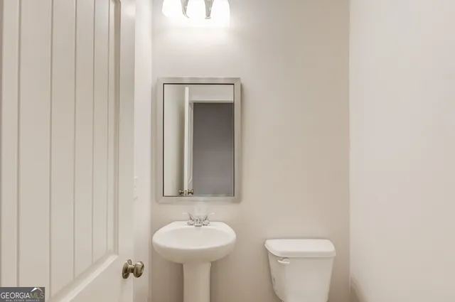 a view of staircase with lots of frames on wall and a window