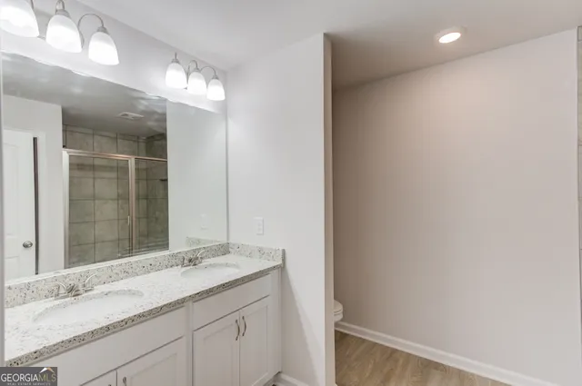 a bathroom with a glass shower door