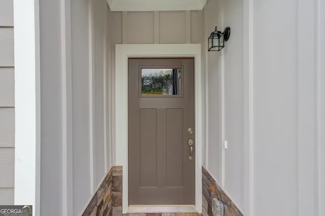a view of a hallway with wooden floor and closet