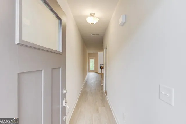 a view of a kitchen with a sink and a refrigerator