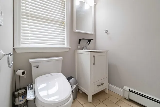 a white toilet sitting next to a bathroom sink