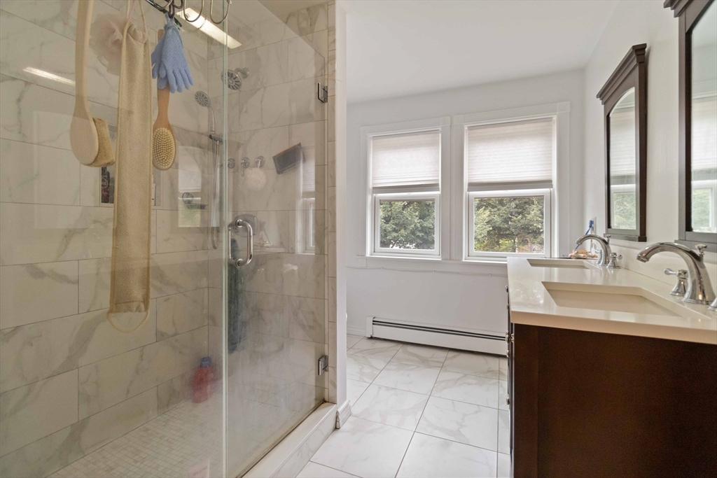 141 Gardiner Road Quincy, MA 02169 - Photo 28 of 39 a bathroom with a sink shower and a mirror