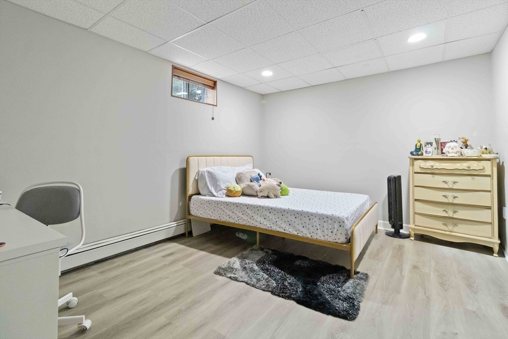 141 Gardiner Road Quincy, MA 02169 - Photo 33 of 39 a bed room with a bed and a chair