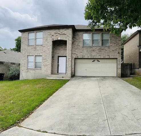 a front view of a house with a garden and garage