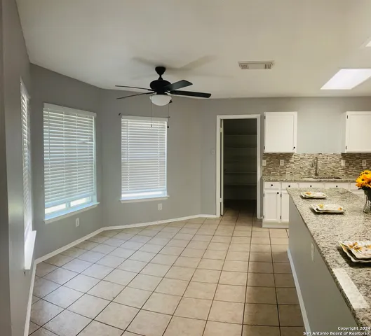 a kitchen with a stove a sink and a refrigerator
