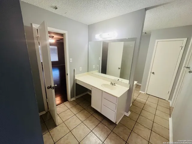 a bathroom with a sink vanity and mirror
