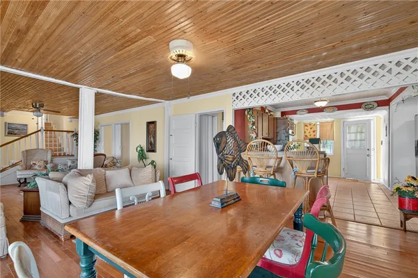 a dining room with furniture window and wooden floor