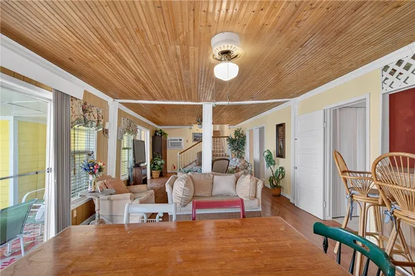 a living room with furniture and large windows