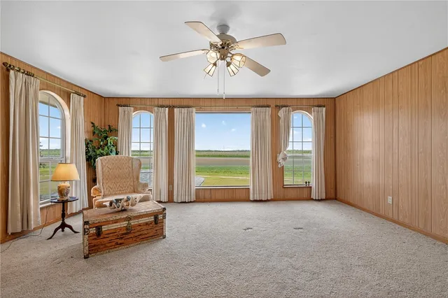 a view of a livingroom with furniture and a large window