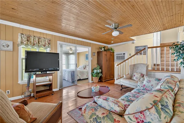 a living room with furniture fireplace and a large window