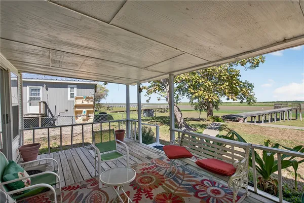 a view of a chairs and table in patio