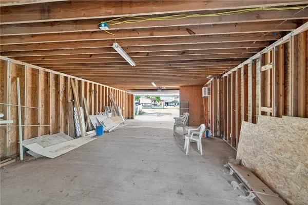 an aerial view of a house with a garden and lake view