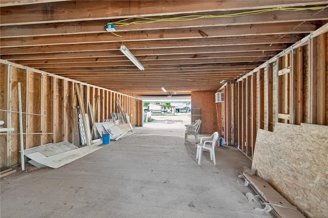 an aerial view of a house with a garden and lake view