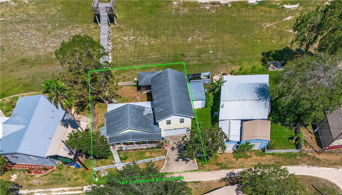 107 Lakefield Drive East Mathis, TX 78368 - Photo 28 of 33 an aerial view of a house with a garden and lake view