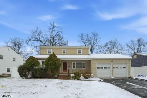 a view of a house with a yard and garage