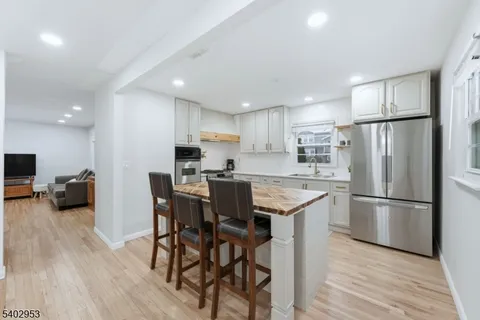 a view of a hallway with wooden floor and entryway