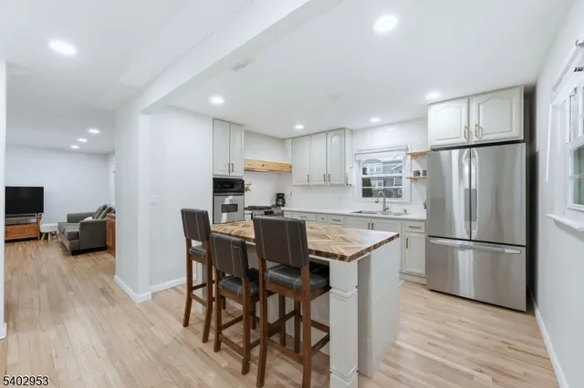 a view of a hallway with wooden floor and entryway