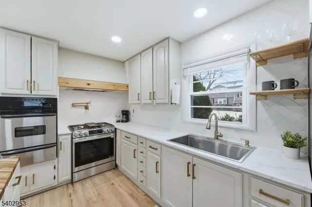 a bathroom with a granite countertop sink and a toilet