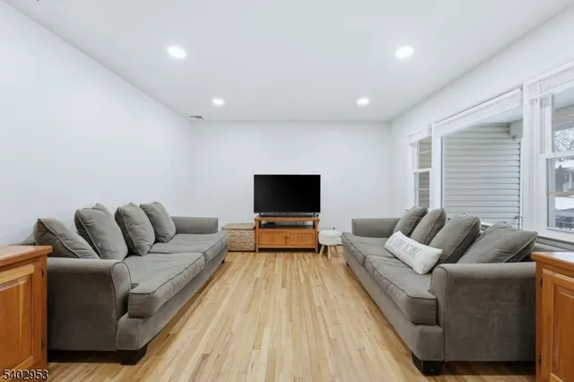 a kitchen with stainless steel appliances a refrigerator a stove a sink dishwasher and a refrigerator with wooden floor