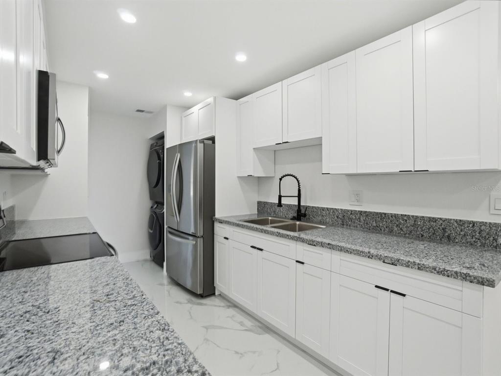 390 Hazel Circle Punta Gorda, FL 33982 - Photo 13 of 44 a kitchen with a refrigerator sink and cabinets