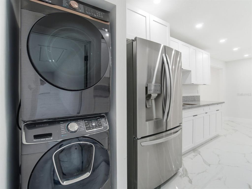 390 Hazel Circle Punta Gorda, FL 33982 - Photo 15 of 44 a metallic refrigerator freezer sitting in a kitchen