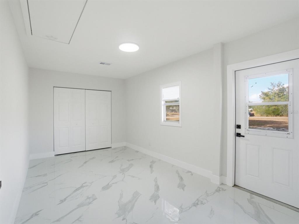 390 Hazel Circle Punta Gorda, FL 33982 - Photo 16 of 44 an empty room with windows