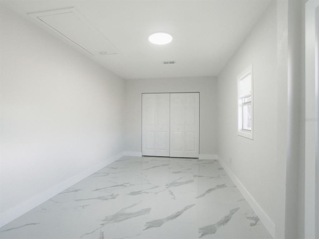 390 Hazel Circle Punta Gorda, FL 33982 - Photo 17 of 44 an empty room with a empty space and windows