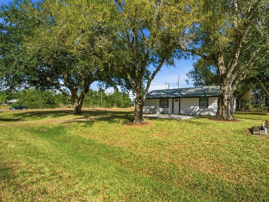390 Hazel Circle Punta Gorda, FL 33982 - Photo 2 of 44 a front view of a house with a yard