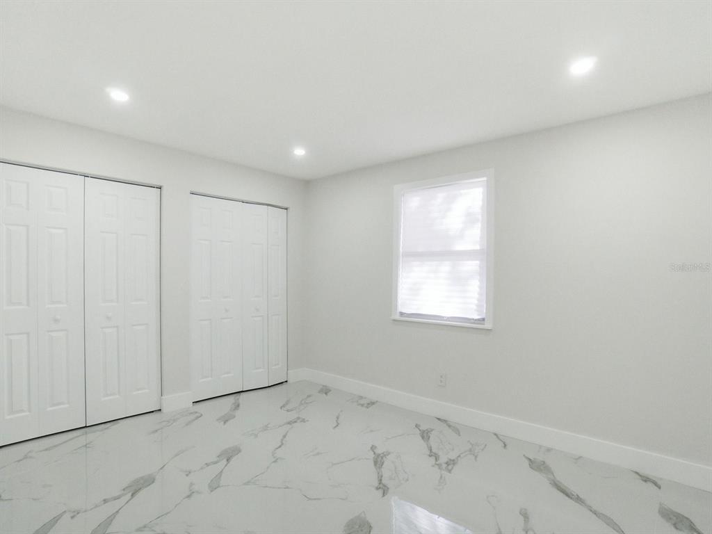 390 Hazel Circle Punta Gorda, FL 33982 - Photo 23 of 44 an empty room with windows