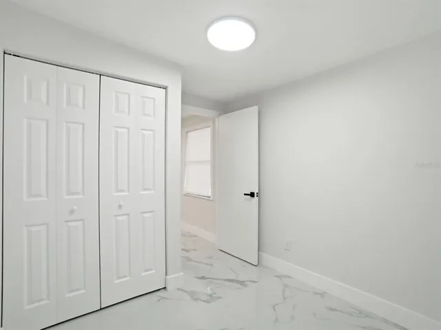 a bed room with furniture and a potted plant