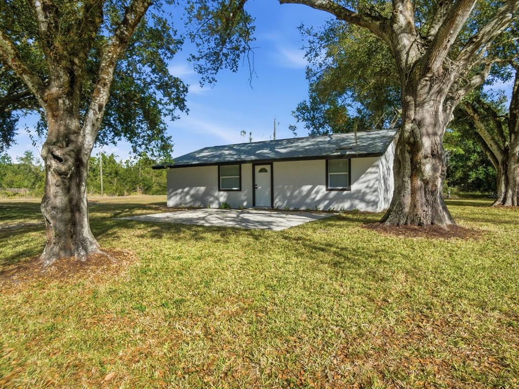 390 Hazel Circle Punta Gorda, FL 33982 - Photo 3 of 44 a front view of a house with garden