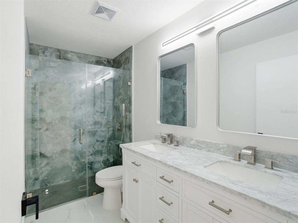 390 Hazel Circle Punta Gorda, FL 33982 - Photo 34 of 44 a bathroom with a granite countertop sink a toilet and a mirror