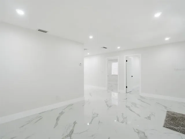 a view of kitchen with white cabinets