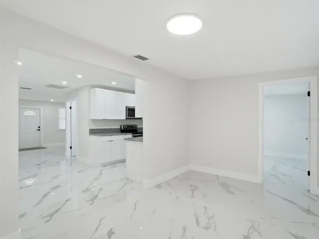 a view of kitchen with white cabinets