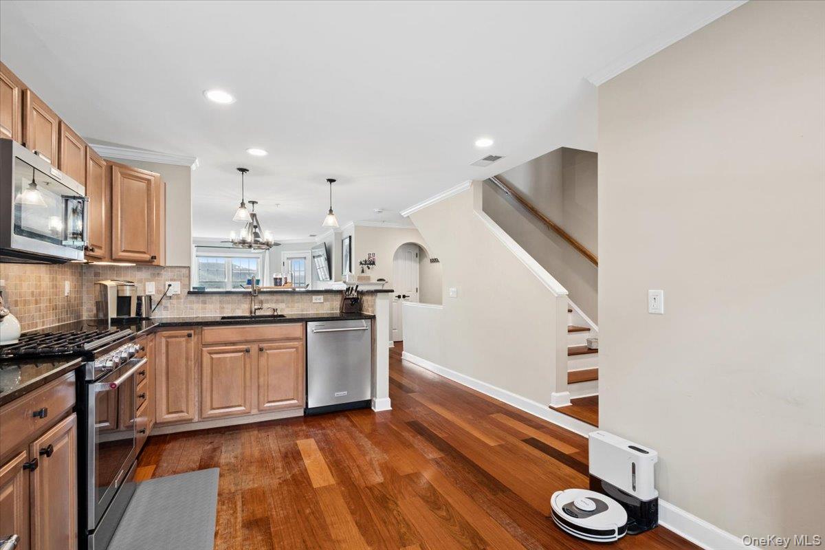 225 Waterside Close Peekskill, NY 10566 - Photo 14 of 40 Kitchen featuring wood-finish flooring, light wood cabinetry, stainless steel appliances, granite countertops