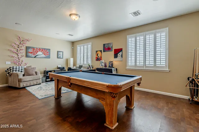 a dining room with furniture and wooden floor
