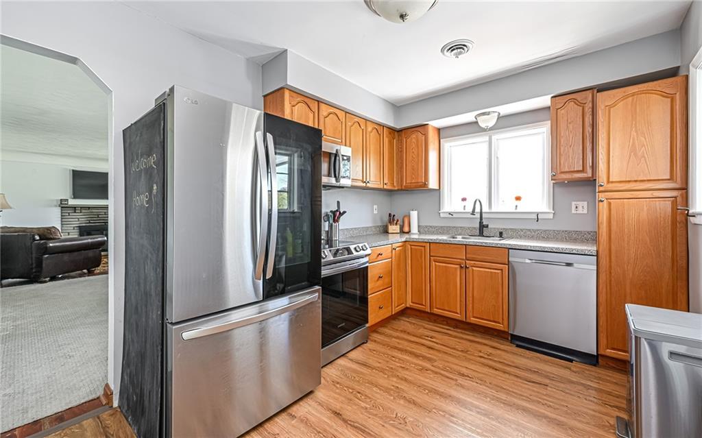 2559 Nicholson Road Sewickley, PA 15143 - Photo 6 of 24 Kitchen has been updated with newer oak cabinets and easy to maintain wood look flooring.