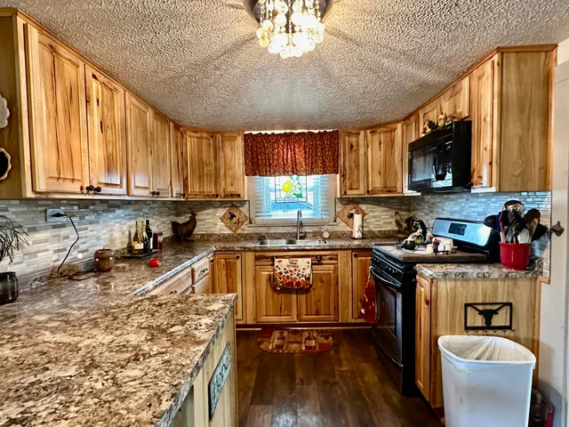 a kitchen with a stove a sink and a microwave
