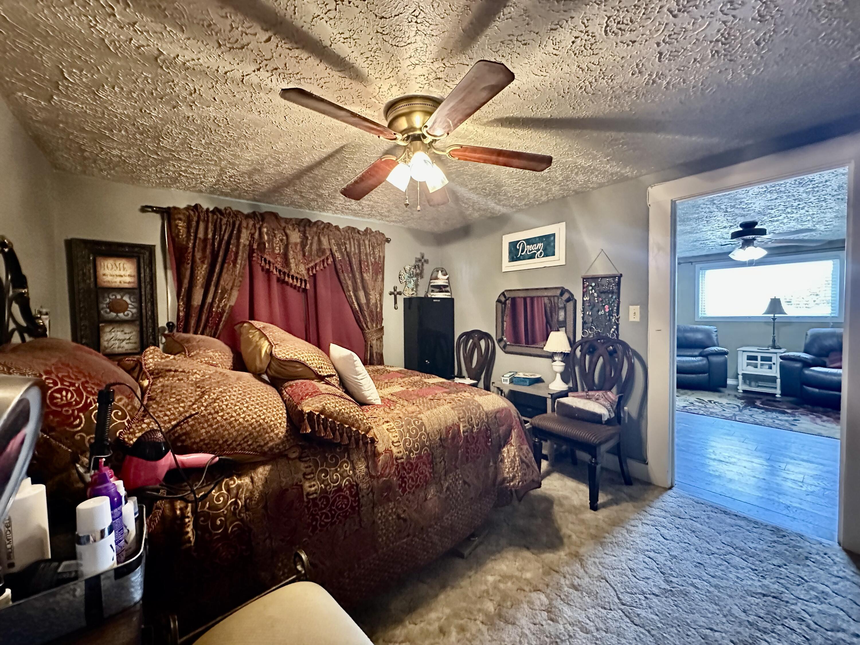 600 Mulberry Street Turkey, TX 79261 - Photo 21 of 29 a bedroom with a bed wooden floor and ceiling fan