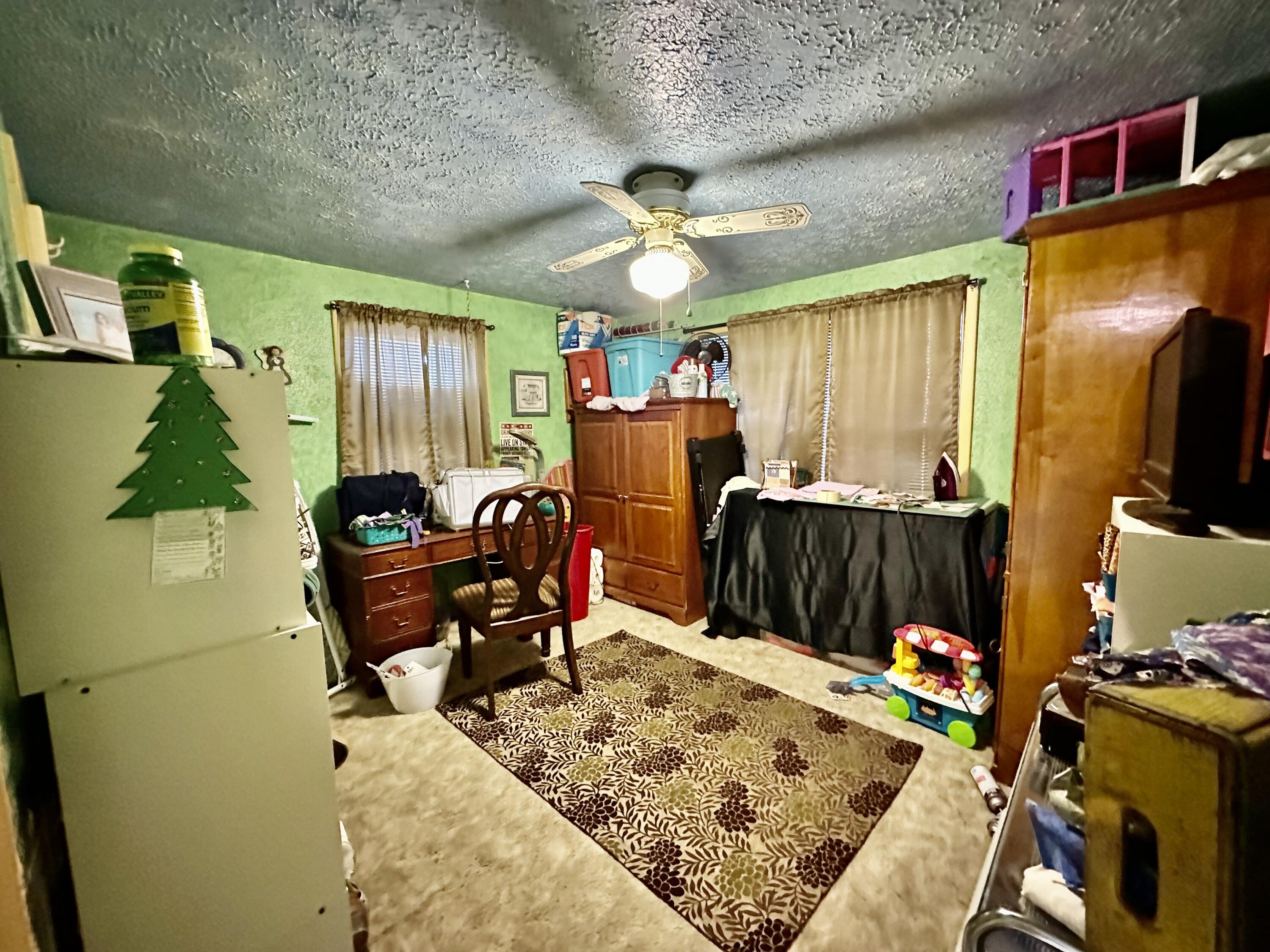 600 Mulberry Street Turkey, TX 79261 - Photo 22 of 29 a bedroom with furniture and a flat screen tv