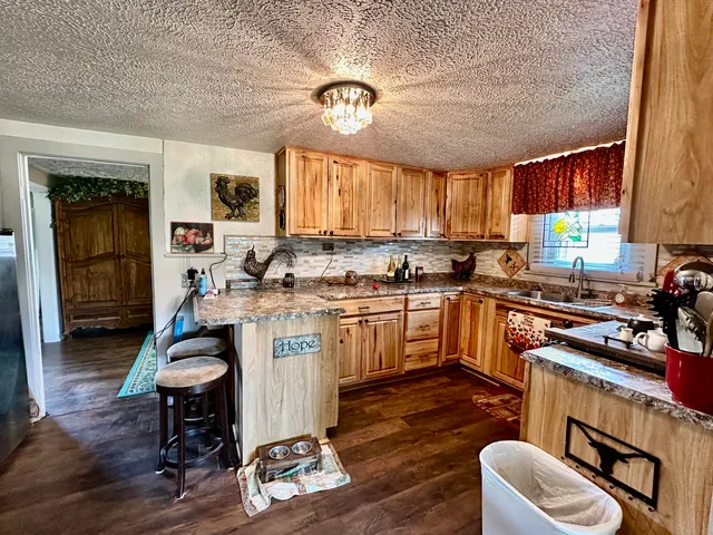 a kitchen with a refrigerator cabinets and a table