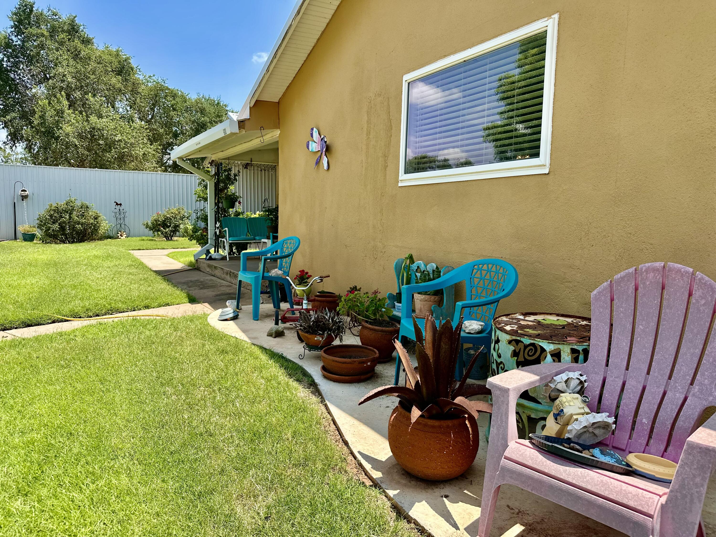 600 Mulberry Street Turkey, TX 79261 - Photo 29 of 29 a view of a backyard with table and chairs potted plants and a fountain