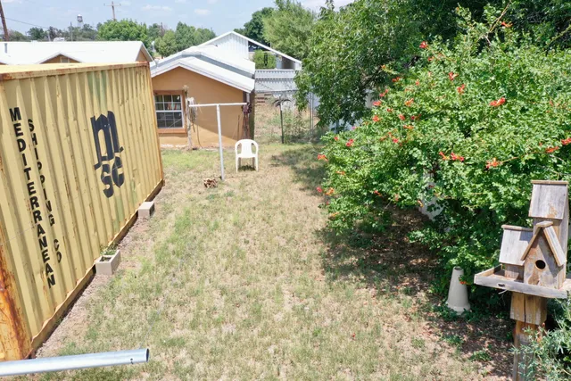 a view of a house with backyard and sitting area
