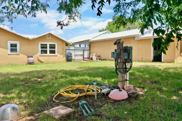 a backyard of a house with table and chairs
