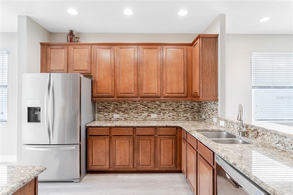 337 Partridge Pea Lane Ocoee, FL 34761 - Photo 12 of 38 a kitchen with stainless steel appliances granite countertop a refrigerator and a sink