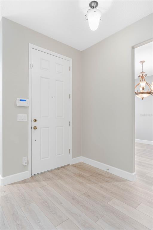 337 Partridge Pea Lane Ocoee, FL 34761 - Photo 14 of 38 a view of a room with wooden floor and a ceiling fan