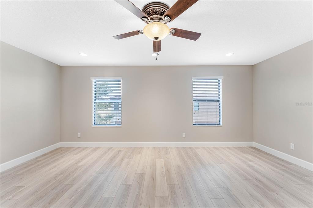 337 Partridge Pea Lane Ocoee, FL 34761 - Photo 16 of 38 wooden floor in an empty room with a window