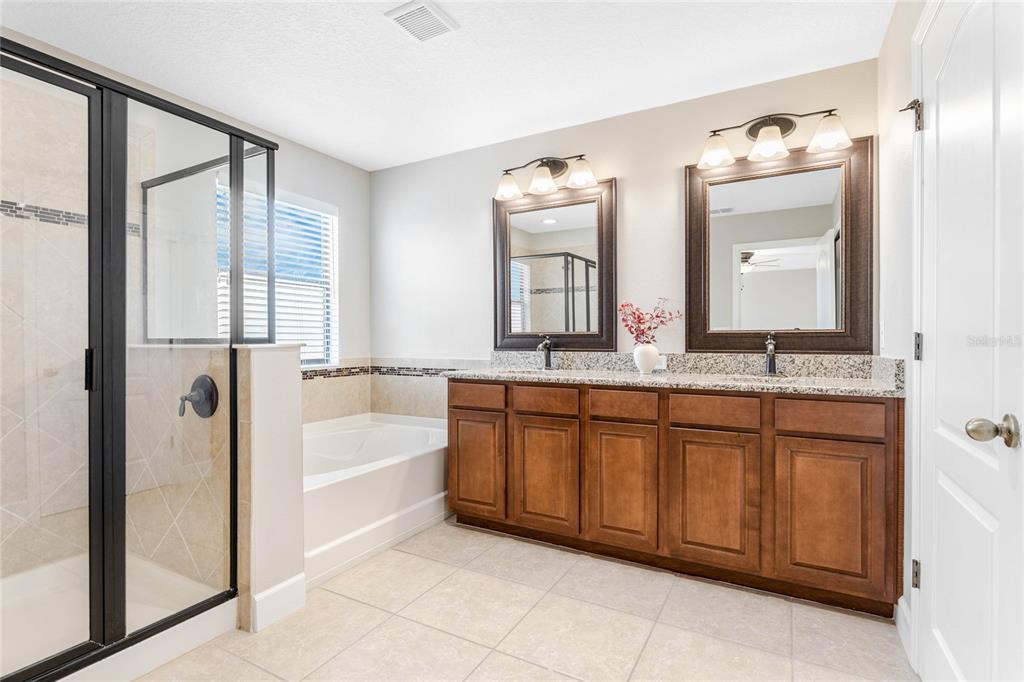 337 Partridge Pea Lane Ocoee, FL 34761 - Photo 18 of 38 a spacious bathroom with a tub sink and mirror