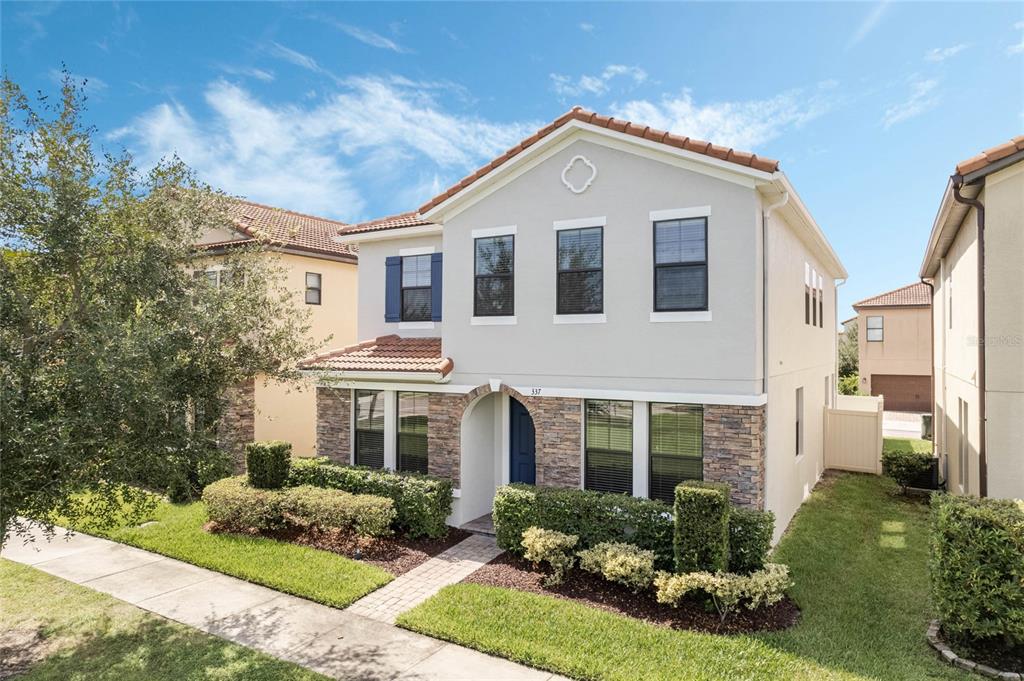 337 Partridge Pea Lane Ocoee, FL 34761 - Photo 2 of 38 a front view of a house with a yard